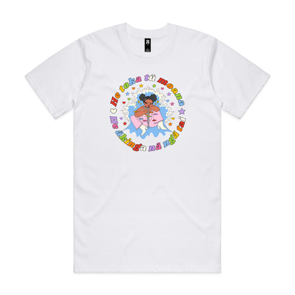A white T-shirt with a person with a moko kauae and a crutch amid a splash and stars, surrounded by colourful text reading “He toka tū moana, he ākinga nā ngā tai.”
